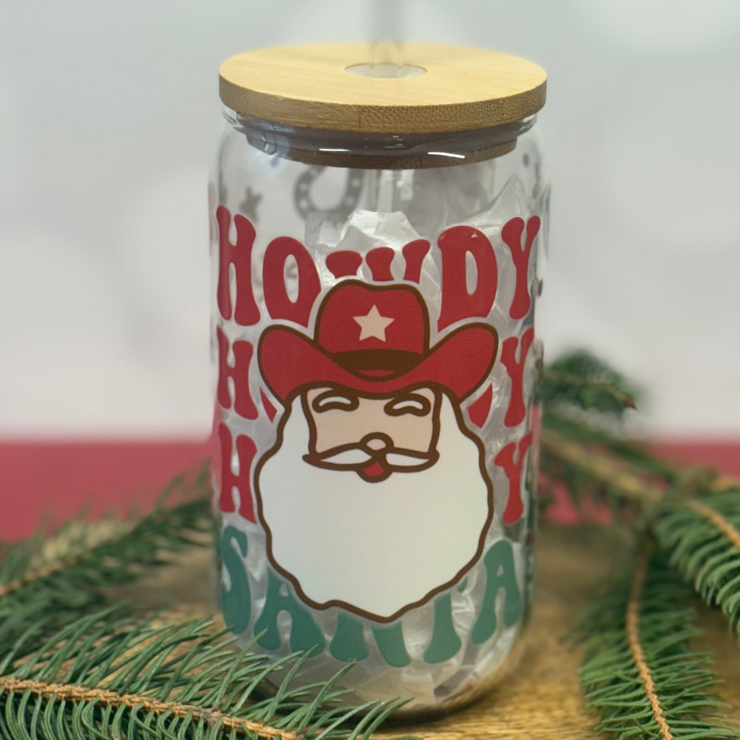Glass jar with wooden lid and 'Howdy Ho Santa' label on a light background