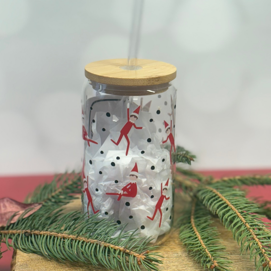 Glass tumbler with wooden lid and Christmas-themed design on a white background