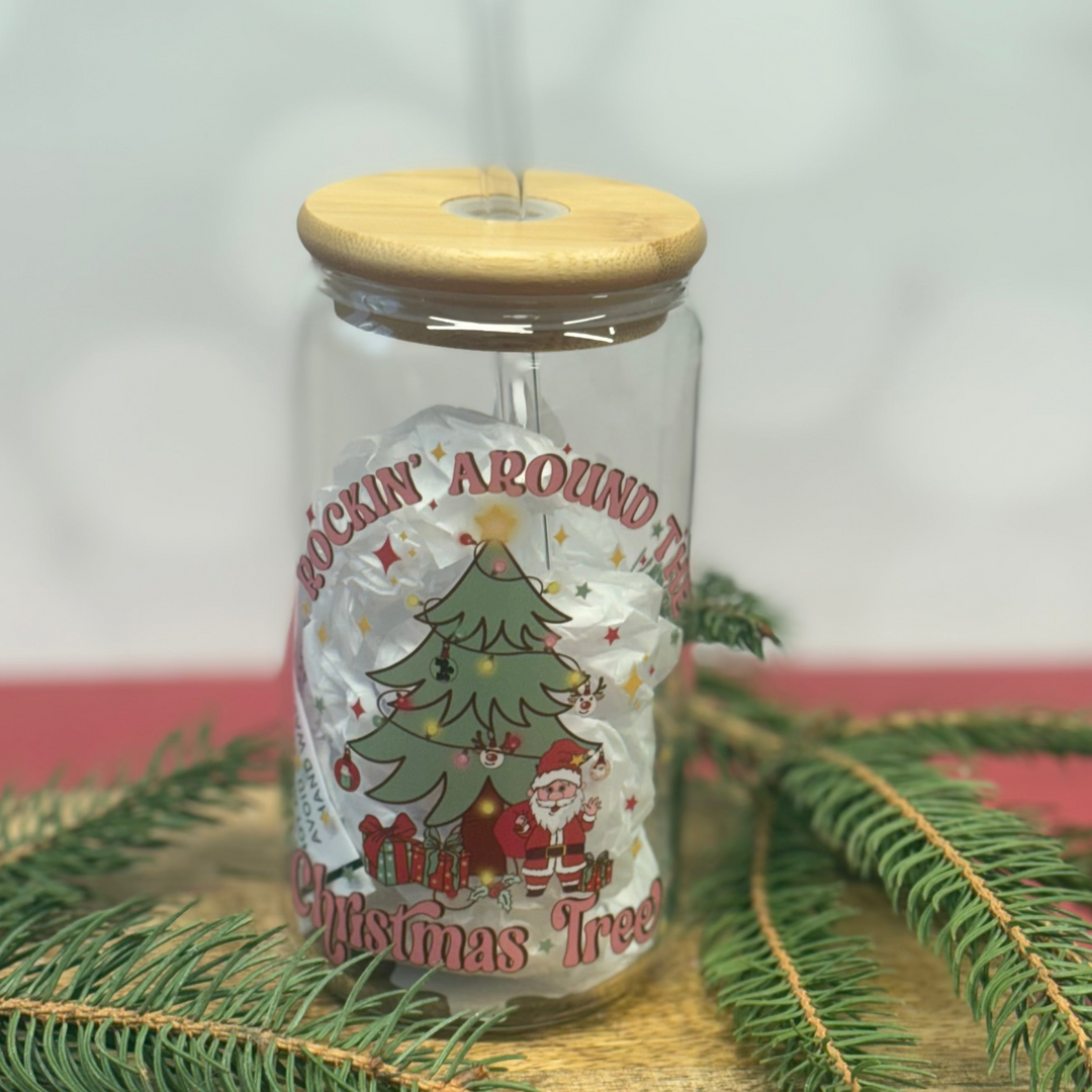 Decorative glass jar with wooden lid and Christmas-themed design on a white background