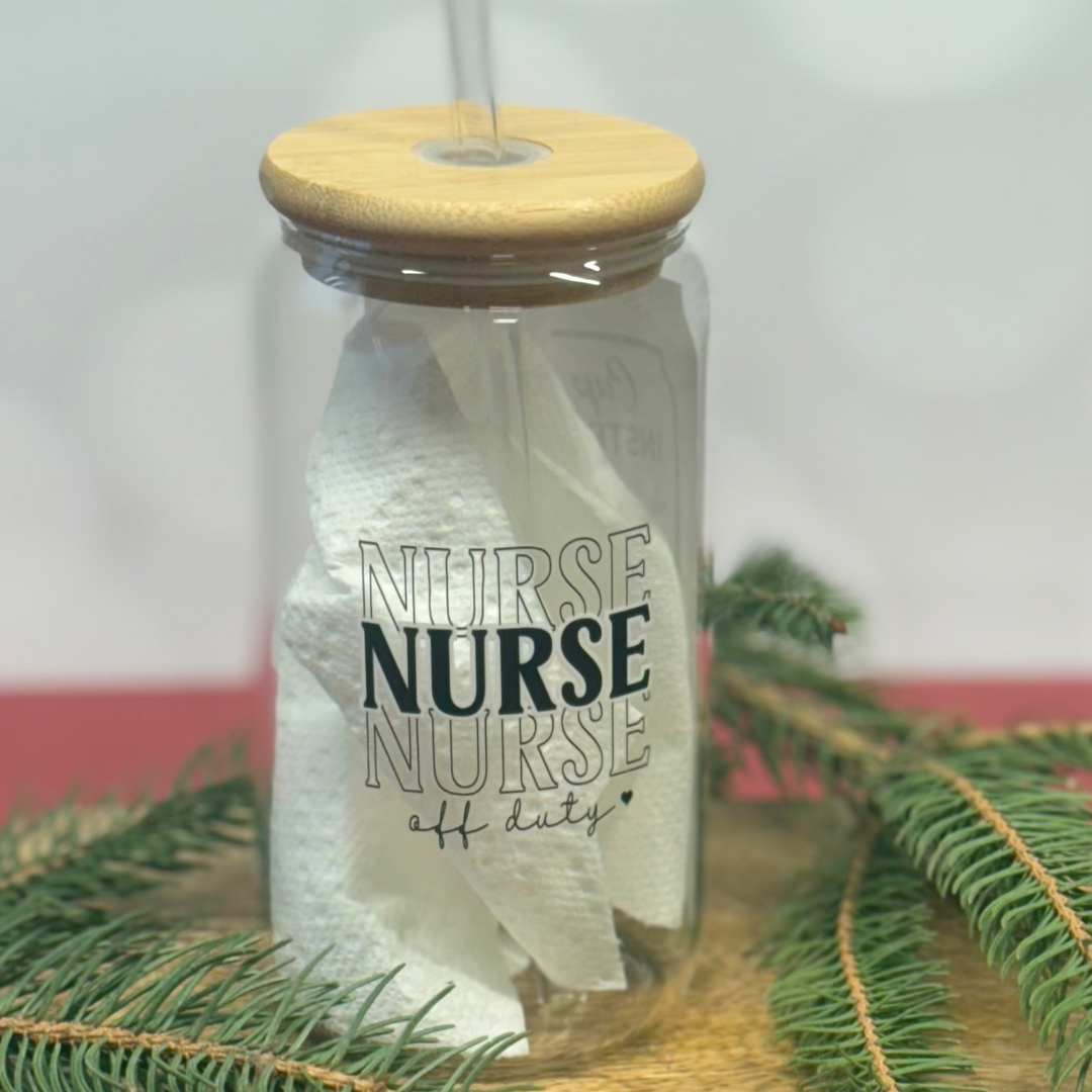Mason jar with wooden lid and 'NURSE' text, surrounded by greenery on a light background