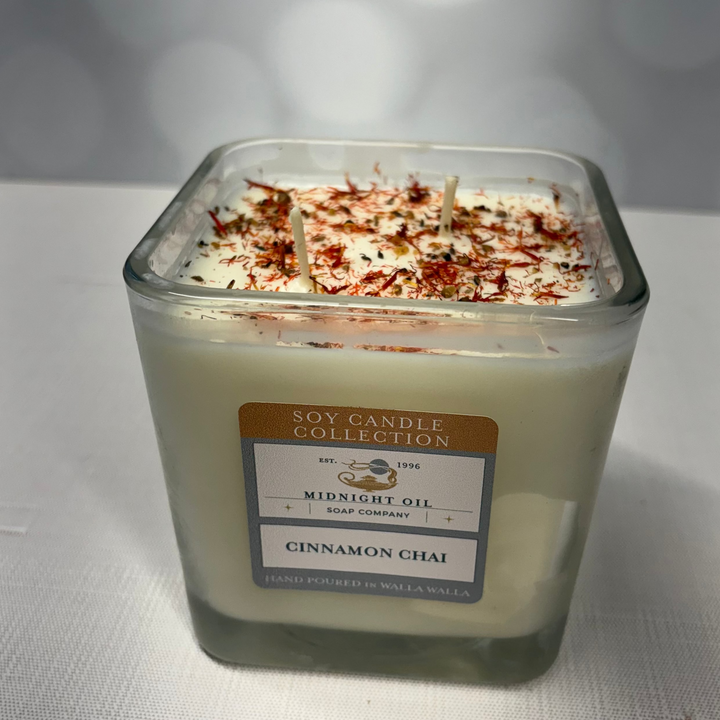 Soy candle in a glass jar with a label on a white background